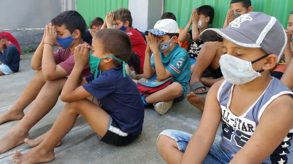 children praying during pandemic